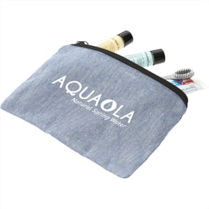 A blue recycled cotton twill pouch with a logo, containing toiletries like lotions and a hairbrush.