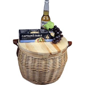 Wicker cooler basket in natural colour with a wooden lid, featuring crackers, grapes, and a drink bottle.
