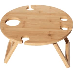 A circular bamboo picnic table with four drink holders and wooden legs, featuring a natural finish.