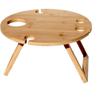A round bamboo picnic table with cut-out sections for drinks, featuring wooden legs. It has a natural finish.