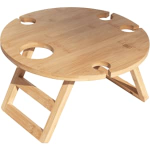 A round bamboo picnic table featuring four cup holders and a folding design. It has a natural finish.