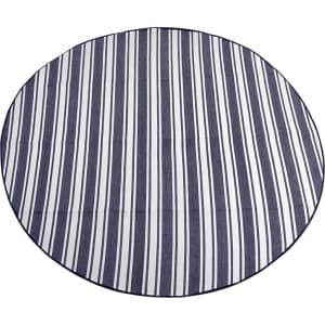A round picnic rug featuring navy and white striped design with a solid border. It has a branding logo.
