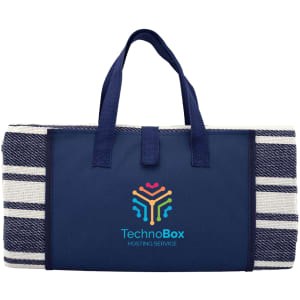 A navy blue picnic rug with a striped pattern and carrying handles, featuring a logo on the front.