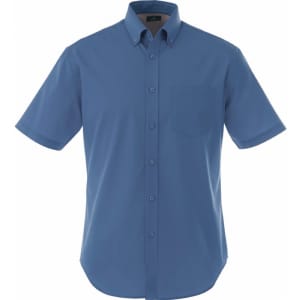 A short sleeve button-up shirt in blue with a chest pocket and a logo on the label.