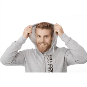 A man in a grey fleece zip hoody, smiling and pulling the hood over his head, with branding visible on the garment.