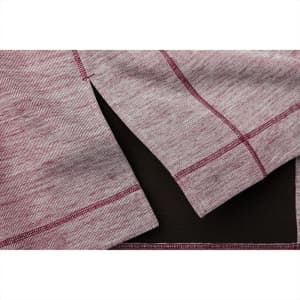 A close-up of a maroon and grey knitted half zip jumper, featuring side slits and contrasting stitching.