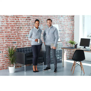 A grey knitted half zip jumper is worn by a man and woman in a stylish office setting, featuring casual attire.