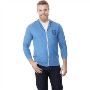 A blue men's full zip hoodie with a logo on the chest, paired with dark jeans.