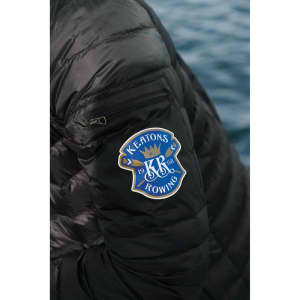 A black puffer jacket featuring a logo on the sleeve, showcasing its light down design.