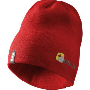 A red knit beanie featuring a logo, suitable for unisex wear.