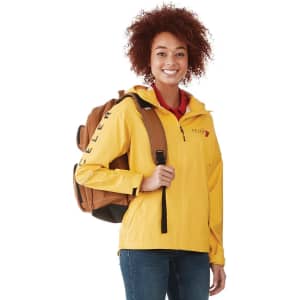 A yellow women's rain jacket with a hood, worn by a smiling person holding a brown backpack.