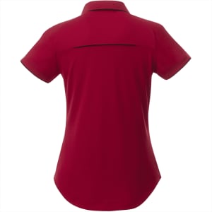 A women's short sleeve polo shirt in a rich burgundy colour, featuring a back yoke and a subtle logo.