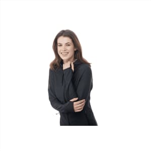 A woman wearing a black Kaiser Knit Jacket, smiling and holding the front, showcasing its design and fit.