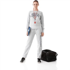 A woman in a grey fleece crew jumper and matching pants stands with a bag, holding a clipboard.