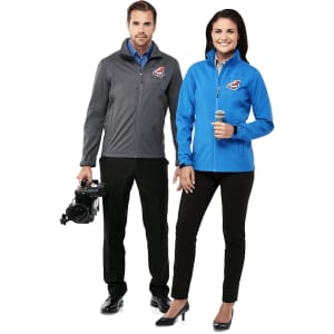 A grey and blue softshell jacket for women, featuring a logo, displayed on a model.
