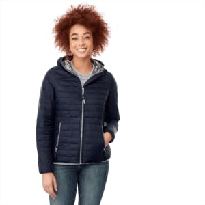 A navy packable insulated jacket for women featuring a hood and a silver inner lining, with a side pocket and branding.