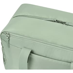 A green duffle bag with a zippered closure and side handles, featuring a smooth fabric surface.