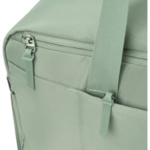 A green duffle bag features a zipper and straps, with pockets on the side and a logo.