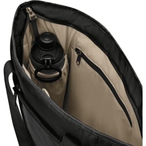 A black tote bag with a beige interior features a drink bottle in a side pocket and a zipped compartment.