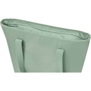 A mint green tote bag with two shoulder straps and an open top, featuring a simple design.