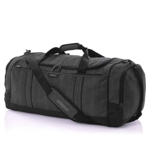 A grey duffle bag with multiple zippered pockets and a removable shoulder strap. It features a logo.