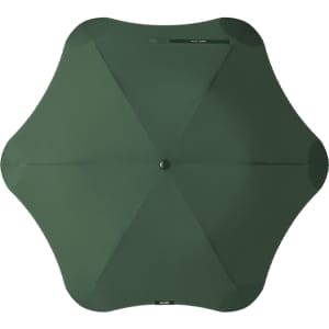 A green BLUNT Metro umbrella with a unique octagonal shape and a central button for opening and closing.