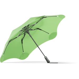 A green BLUNT Metro Umbrella with a black handle and a unique frame design. It features a logo on the fabric.