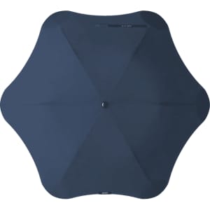 A navy BLUNT Metro Umbrella with a unique octagonal shape and a central button, featuring a logo.