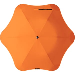 An orange BLUNT Metro Umbrella with a unique octagonal shape and central button for opening and closing.