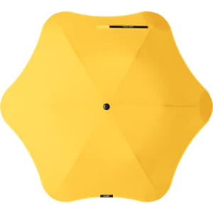 A yellow BLUNT Metro Umbrella with a distinctive design and a central button. It features a logo.