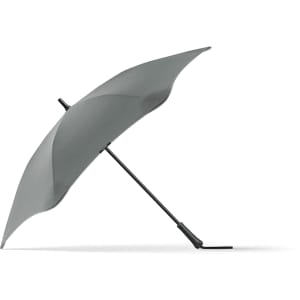 A grey BLUNT Classic Umbrella with a unique, aerodynamic shape and a curved canopy, featuring a logo on the handle.