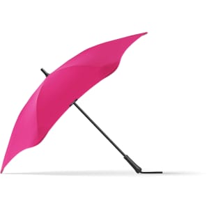 A pink BLUNT Classic Umbrella with a sleek design and a black handle, resting on a flat surface.