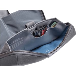 A grey tech kit with multiple compartments, featuring slots for memory cards and a soft blue lining.
