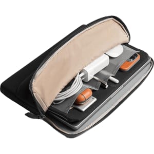 A black laptop caddy featuring a light interior, holding tech accessories, cables, and a laptop. It has a branded logo.