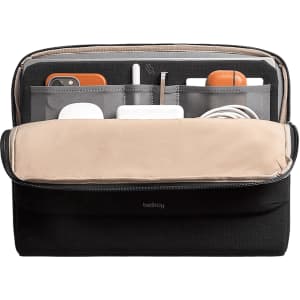 A black laptop caddy with a beige interior, featuring multiple compartments for devices and accessories.