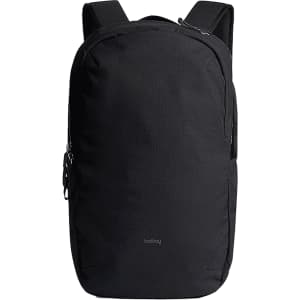 A black backpack with adjustable straps, featuring a logo and a sleek, minimalist design.
