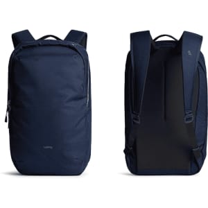 A navy backpack with a sleek design, featuring padded straps and a logo. Dual zip closures on the front and side.