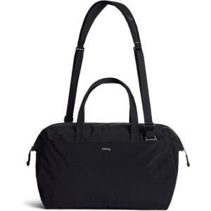 A black duffel bag with a detachable strap and dual handles, featuring a logo on the front.