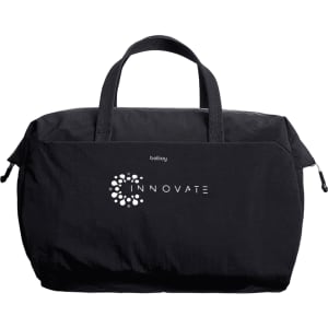 A black duffel bag with short handles and a branding logo on the front.