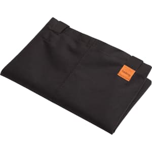 A folded black tote bag with a small logo tag, showcasing its minimalistic design and fabric texture.