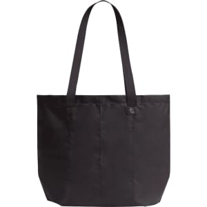 A black tote bag with two long handles and a simple design, featuring a small branding logo.