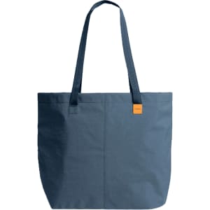 A blue tote bag with two handles and a small logo tag on the side.