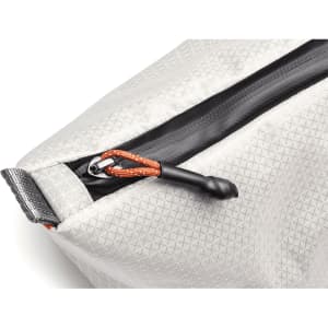 A grey cooler bag with a textured surface and a black zipper, featuring an orange pull tab. It has a logo on it.