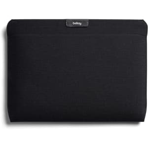 A black laptop sleeve featuring a logo, designed to fit a 16-inch laptop.