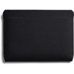 A black laptop sleeve with a smooth, minimalist design and a subtle logo. Suitable for 16-inch laptops.