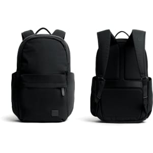 A black backpack with dual compartments and padded straps, featuring a simple design and a logo.