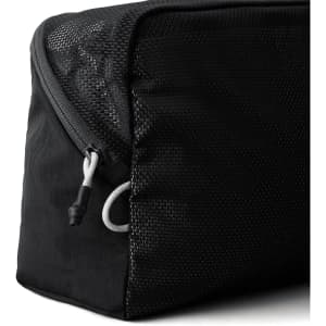 A black packing cube featuring a mesh panel and zip closure, designed for lightweight organisation.