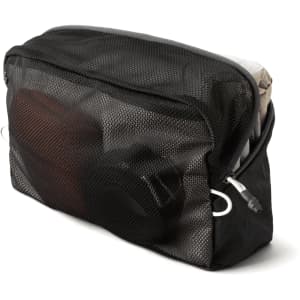 A black mesh packing cube containing various items, showcasing its organisational features and content visibility.