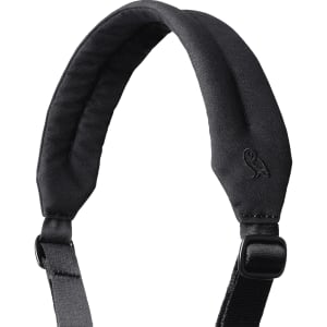 A padded black shoulder strap with an adjustable buckle and a logo at the top.