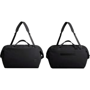 A black duffel bag with dual handles and an adjustable shoulder strap, featuring a logo on the side.
